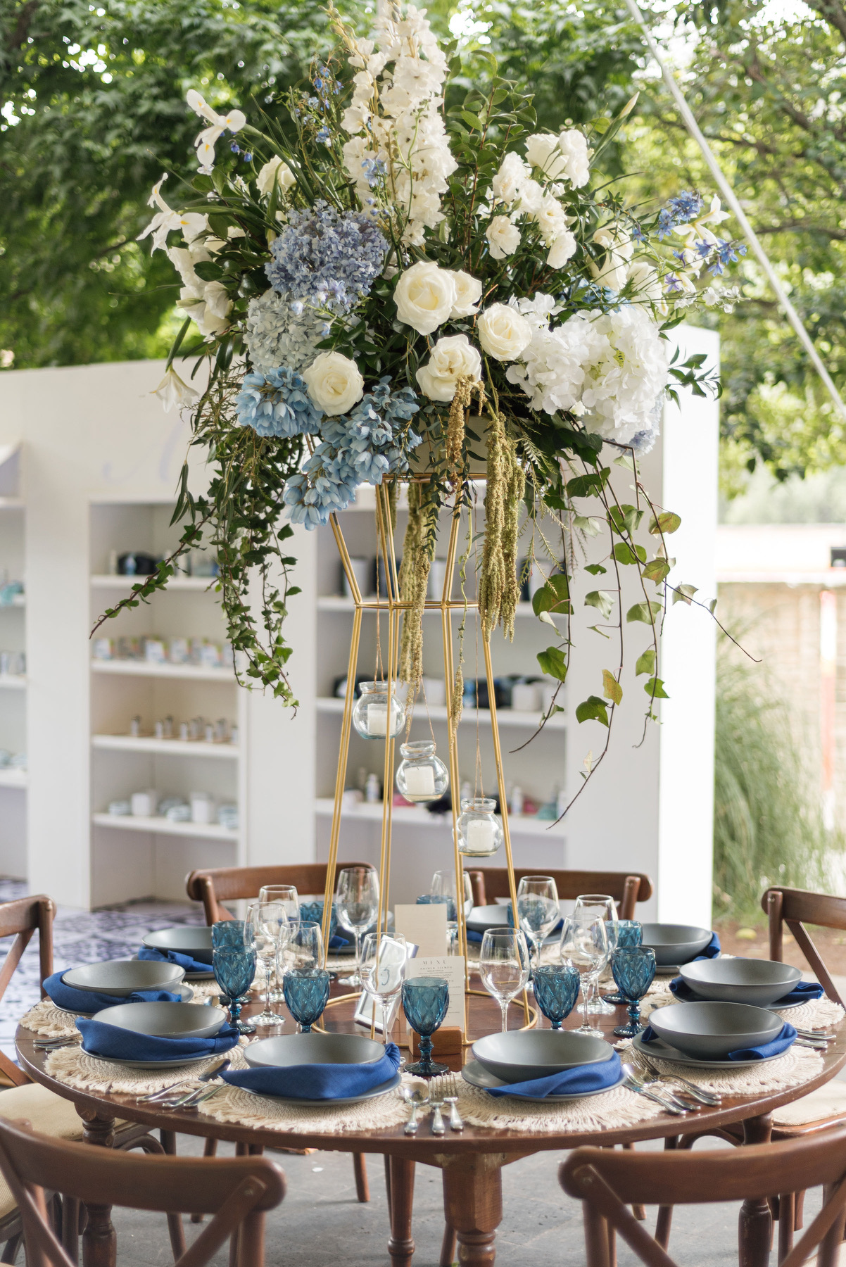 Desk with leather desk pad, walnut desk organizer, wireless keyboard and mouse, and porcelain mug.