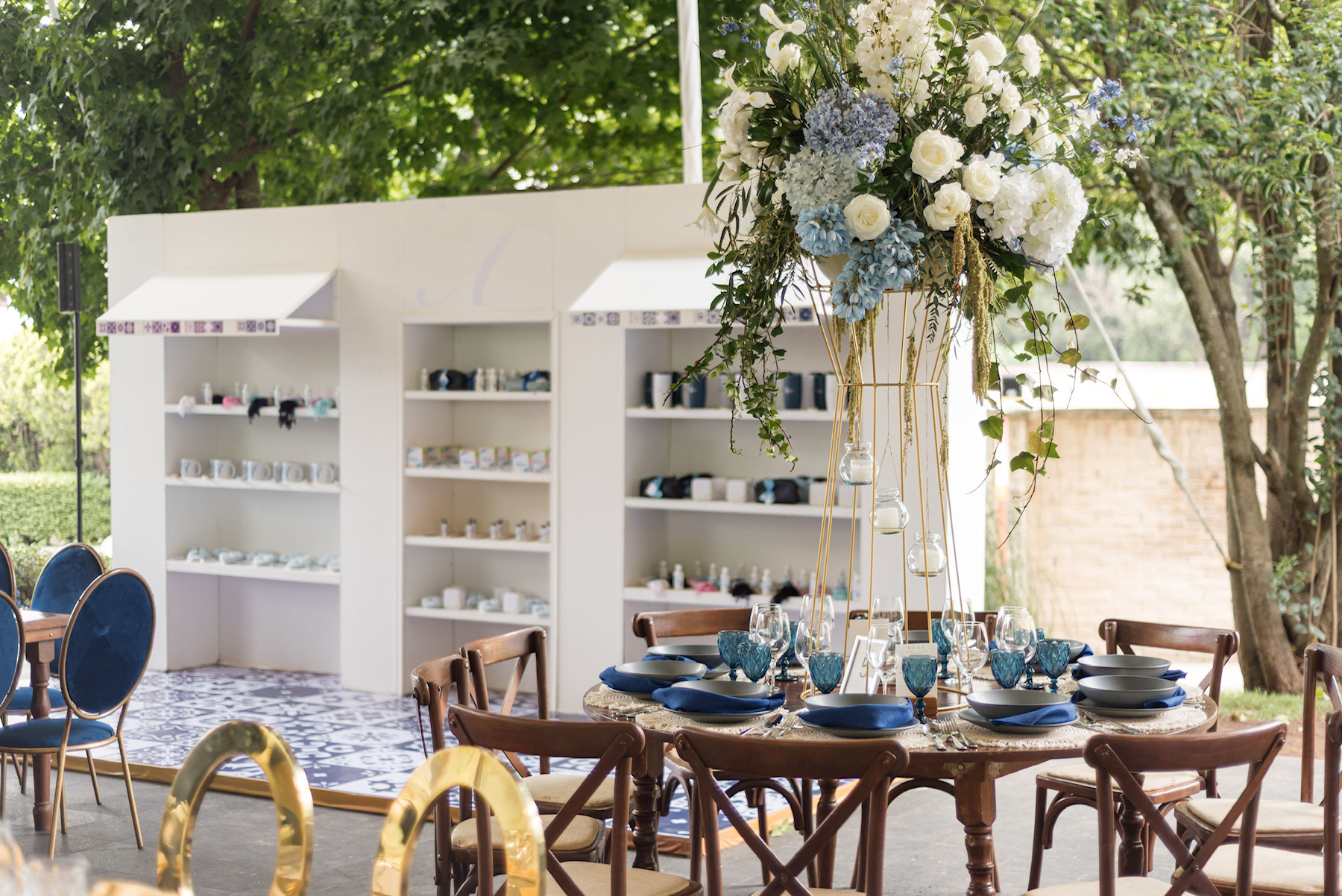 Desk with leather desk pad, walnut desk organizer, wireless keyboard and mouse, and porcelain mug.