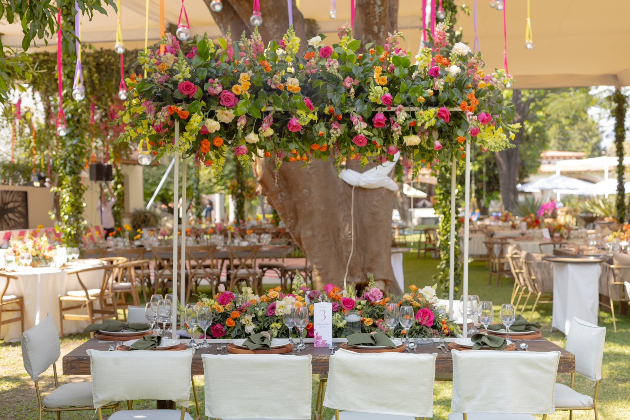 Desk with leather desk pad, walnut desk organizer, wireless keyboard and mouse, and porcelain mug.