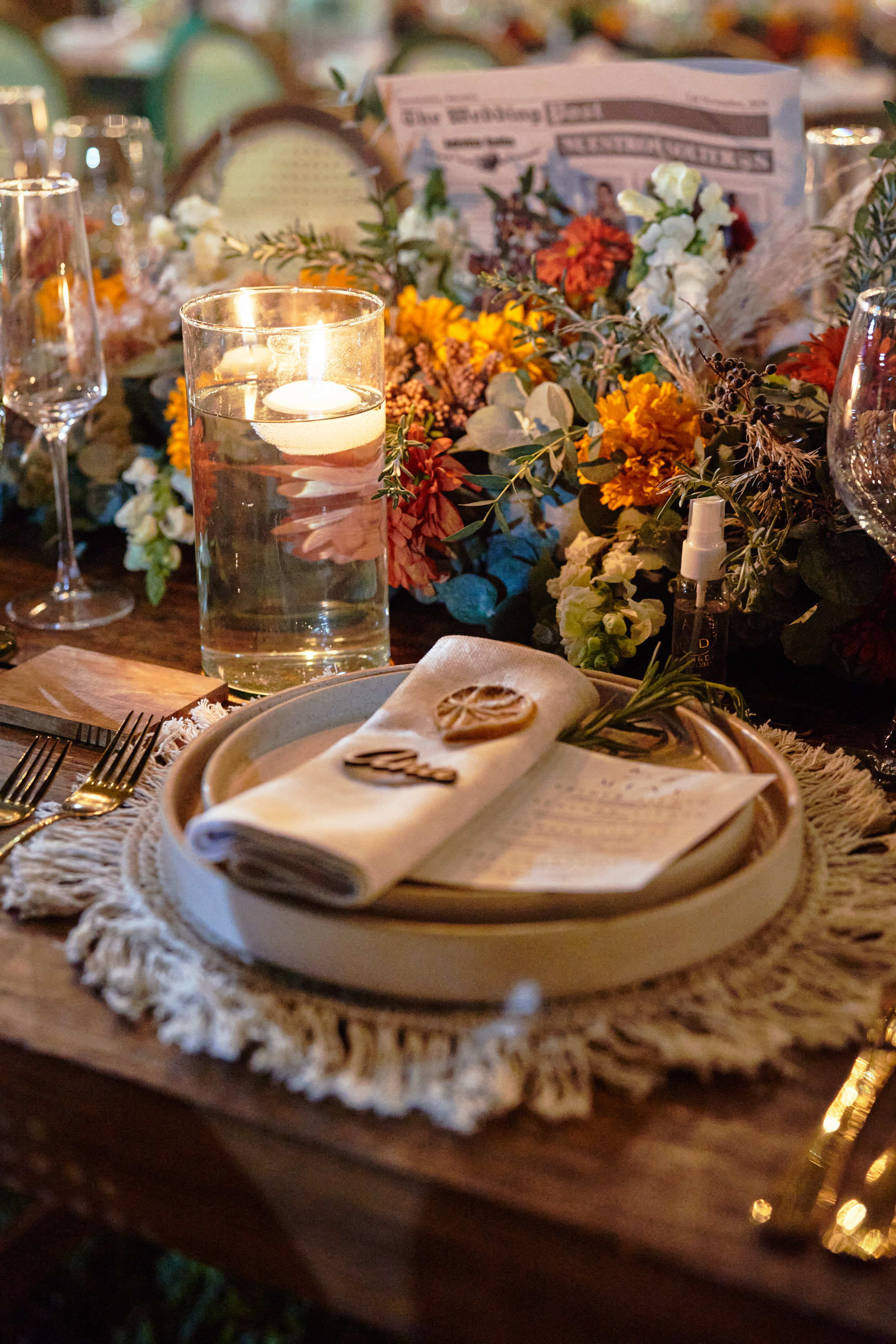 Desk with leather desk pad, walnut desk organizer, wireless keyboard and mouse, and porcelain mug.