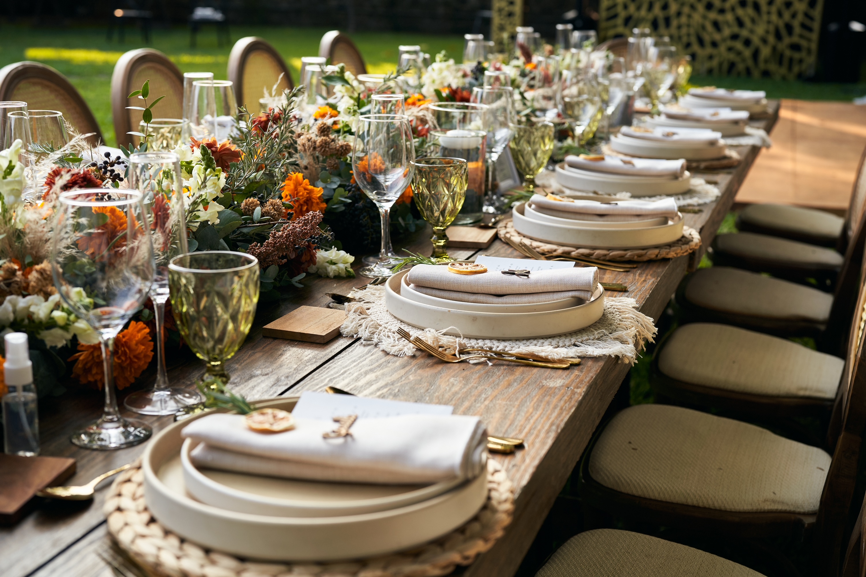 Desk with leather desk pad, walnut desk organizer, wireless keyboard and mouse, and porcelain mug.