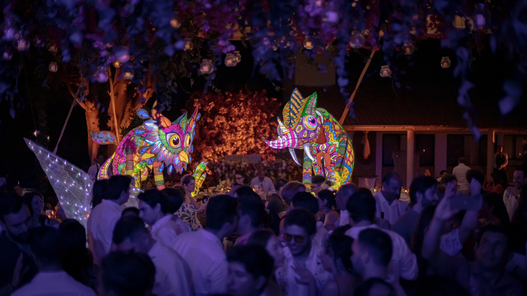 Desk with leather desk pad, walnut desk organizer, wireless keyboard and mouse, and porcelain mug.