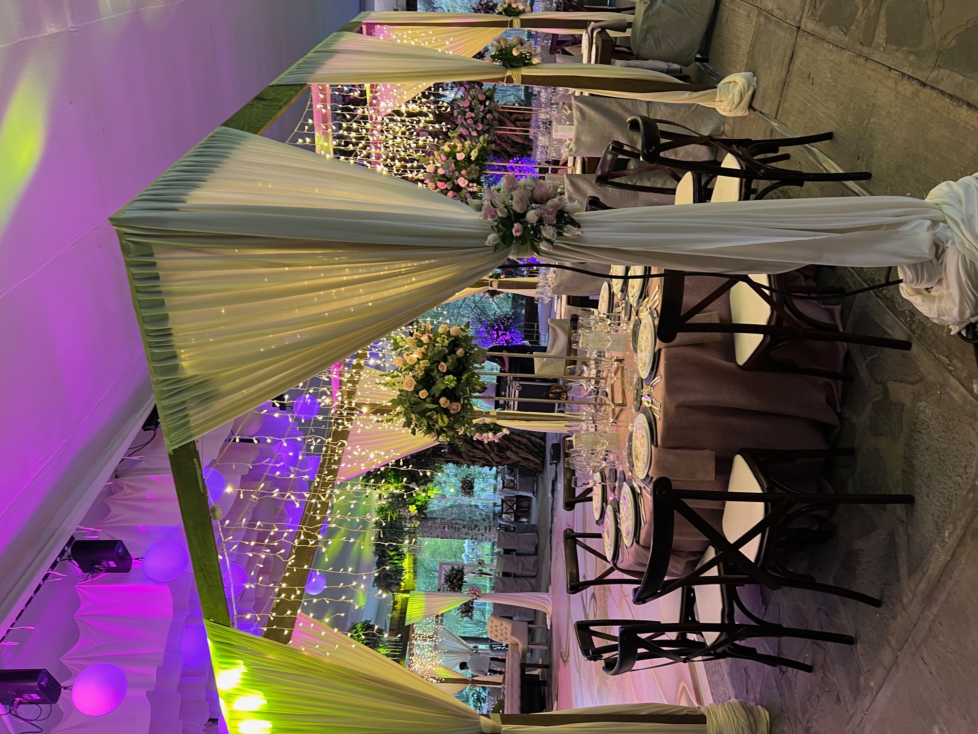 Desk with leather desk pad, walnut desk organizer, wireless keyboard and mouse, and porcelain mug.