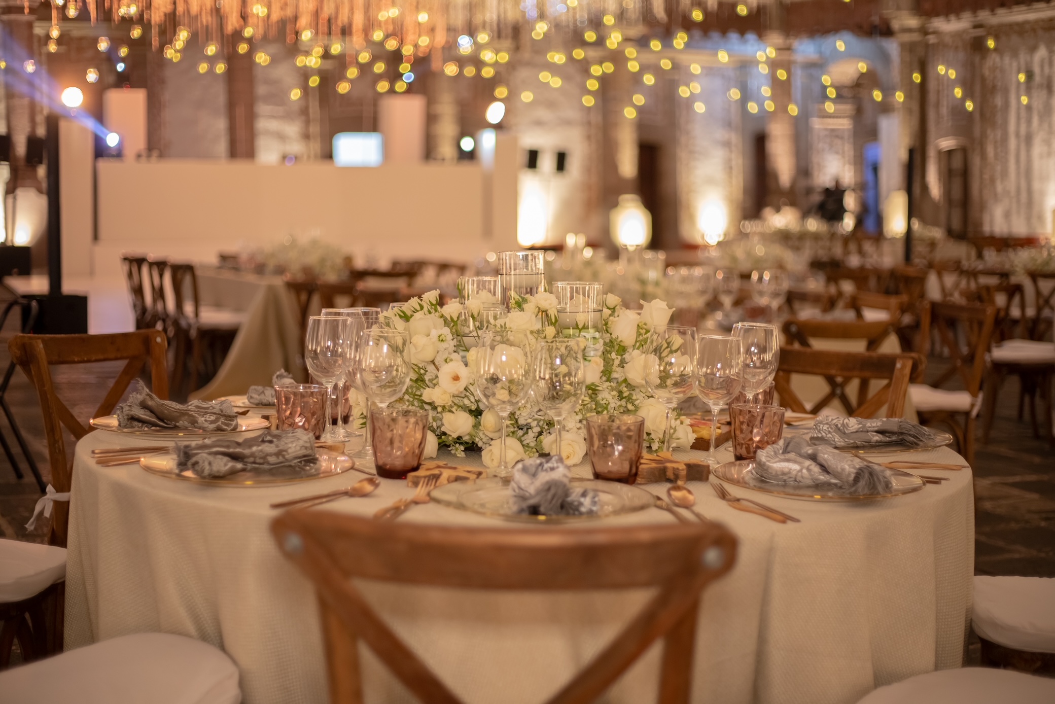 Desk with leather desk pad, walnut desk organizer, wireless keyboard and mouse, and porcelain mug.