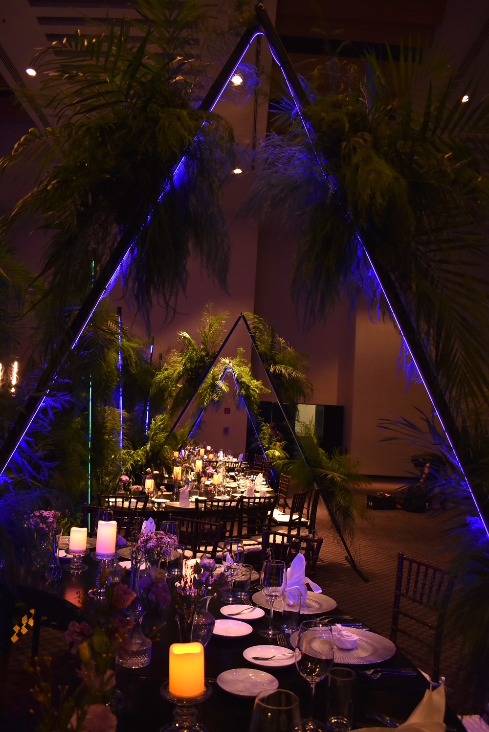 Desk with leather desk pad, walnut desk organizer, wireless keyboard and mouse, and porcelain mug.