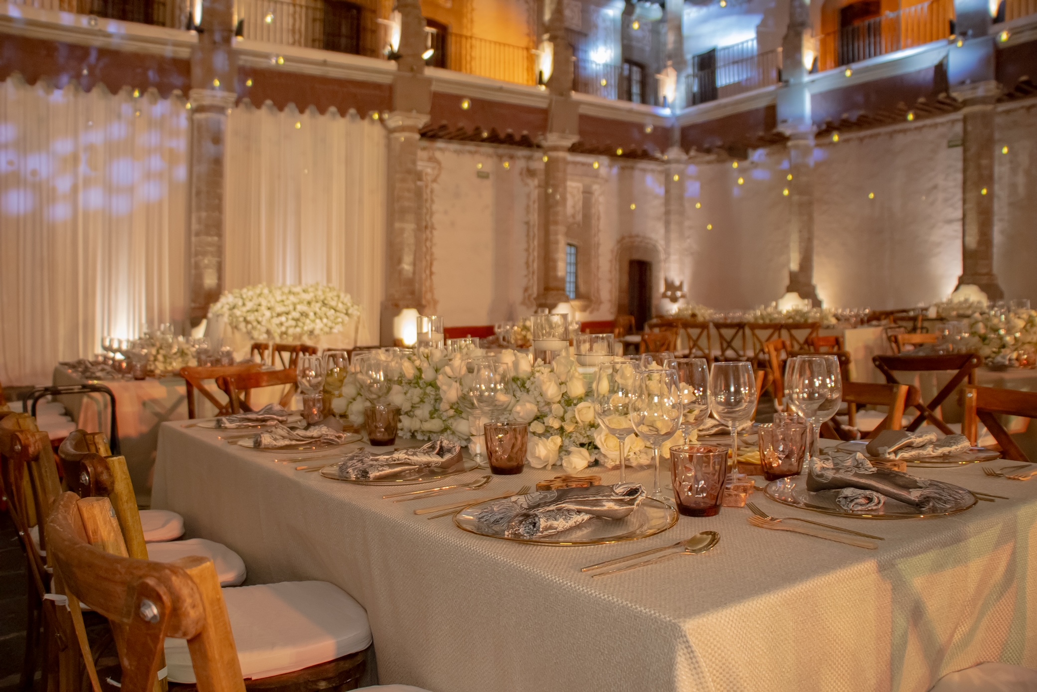 Desk with leather desk pad, walnut desk organizer, wireless keyboard and mouse, and porcelain mug.
