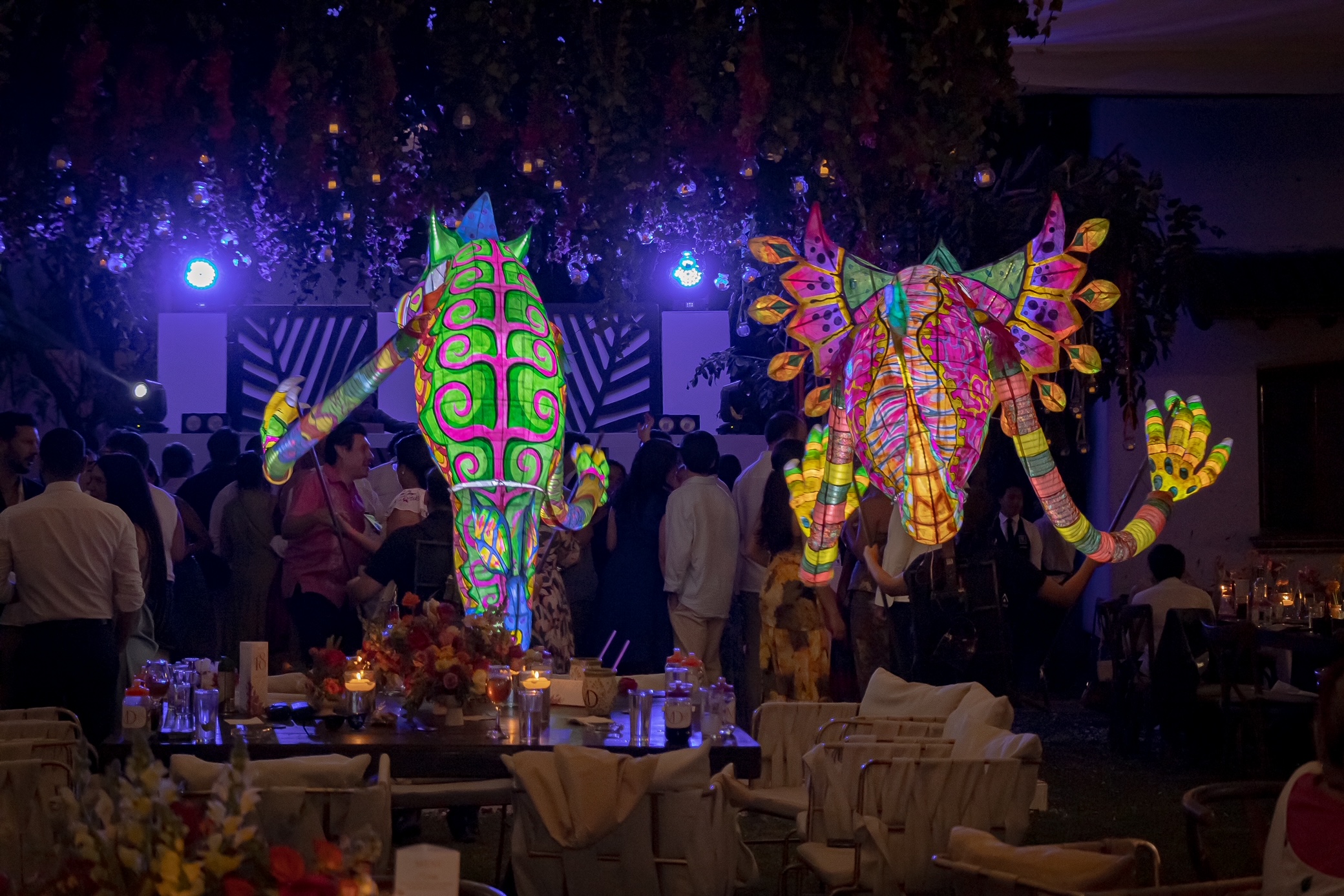 Desk with leather desk pad, walnut desk organizer, wireless keyboard and mouse, and porcelain mug.