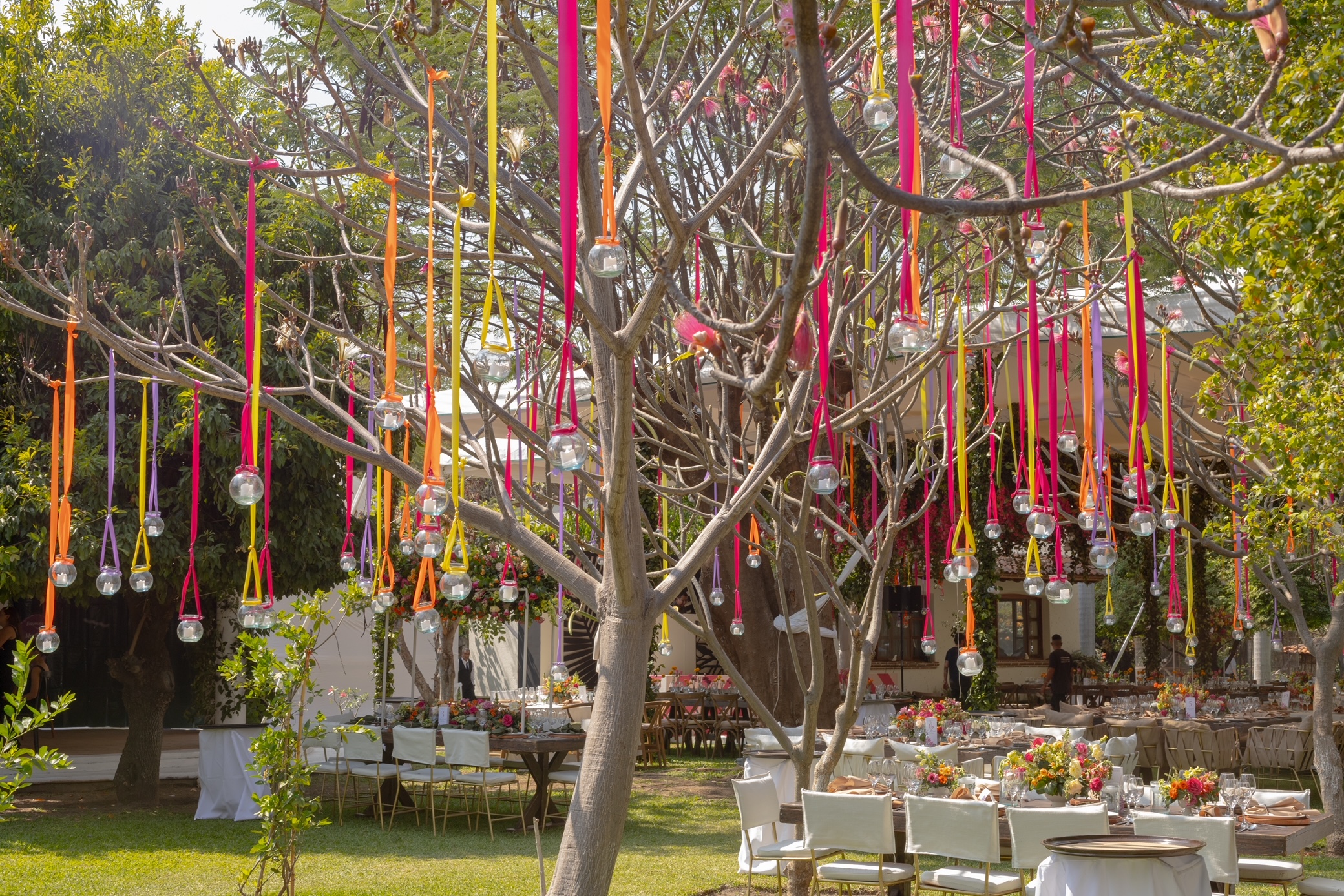 Desk with leather desk pad, walnut desk organizer, wireless keyboard and mouse, and porcelain mug.