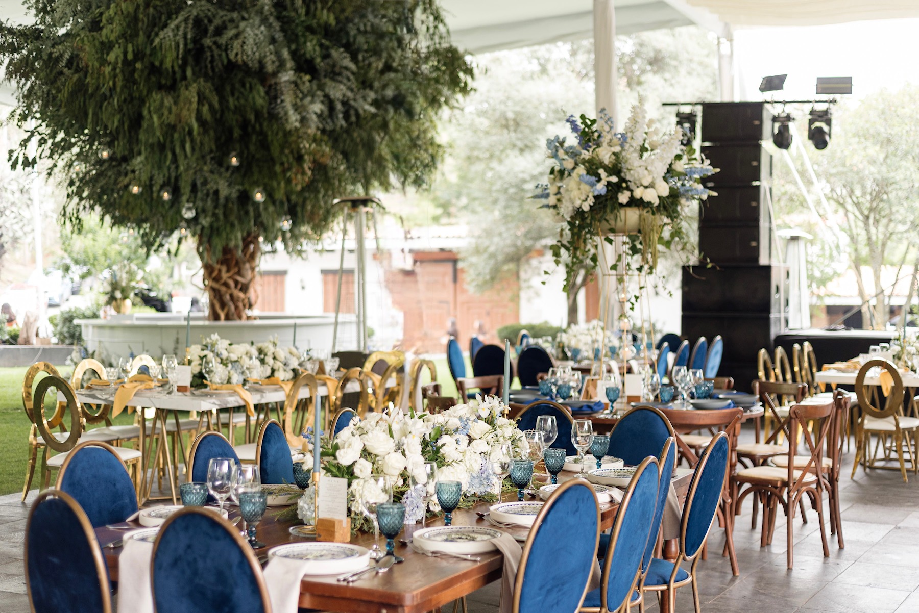 Desk with leather desk pad, walnut desk organizer, wireless keyboard and mouse, and porcelain mug.