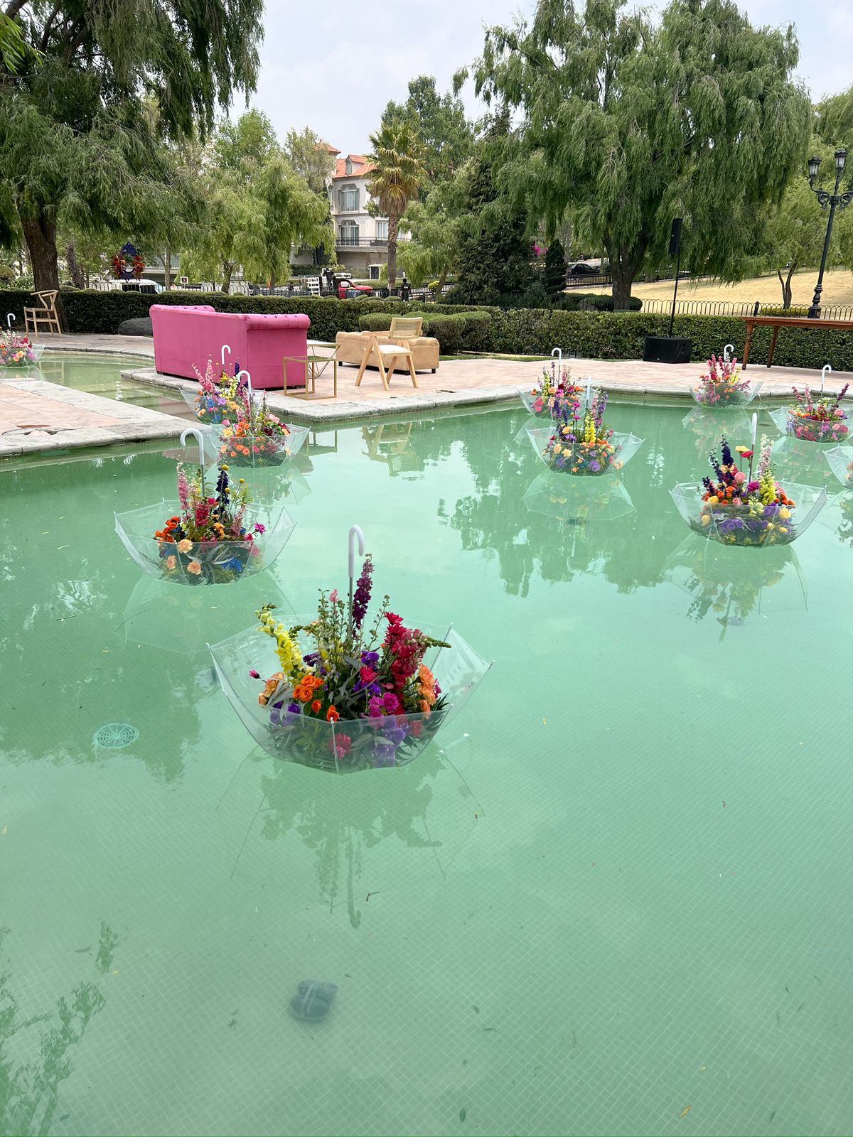 Desk with leather desk pad, walnut desk organizer, wireless keyboard and mouse, and porcelain mug.